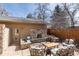 Outdoor living space with a stone fireplace, sitting area, and landscaped features at 2042 S Clayton St, Denver, CO 80210