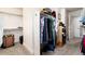 Walk-in closet with ample storage space and rods for hanging clothes plus extra shelving for shoes and other items at 2042 S Clayton St, Denver, CO 80210