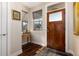 Inviting entryway features a wooden door, hardwood floors, and a charming table with decorative accents and natural light at 2042 S Clayton St, Denver, CO 80210