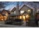 Charming two-story home with stone accents, manicured landscaping, and a welcoming front porch at 2042 S Clayton St, Denver, CO 80210