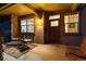 Inviting front porch with seating, a wood door, and visible house number at 2042 S Clayton St, Denver, CO 80210