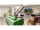 Cozy basement living room with a plush green couch, staircase, and entertainment area at 2042 S Clayton St, Denver, CO 80210