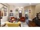 Stylish living room boasts hardwood floors, designer furniture, and plenty of natural light from large windows at 2042 S Clayton St, Denver, CO 80210