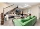 Cozy living room featuring a staircase, TV, built-in shelves, and comfortable seating at 2042 S Clayton St, Denver, CO 80210