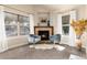 Bright living room with a fireplace, comfortable seating, and large windows for natural light and views at 2042 S Clayton St, Denver, CO 80210