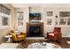 Cozy living room featuring a fireplace, comfortable seating, and plenty of natural light from the large windows at 2042 S Clayton St, Denver, CO 80210