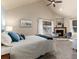 Spacious main bedroom featuring a fireplace, a vaulted ceiling, and soft carpet at 2042 S Clayton St, Denver, CO 80210