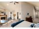 Large main bedroom featuring a vaulted ceiling, a fireplace, and a seating area at 2042 S Clayton St, Denver, CO 80210