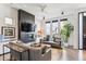 Open concept living room with a modern fireplace and ample natural light at 3048 Stout St, Denver, CO 80205