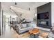 Open living area with a floating staircase, fireplace, and stylish furniture at 3048 Stout St, Denver, CO 80205