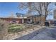 A backyard featuring a pergola with seating area and lush garden at 3456 Quivas St, Denver, CO 80211