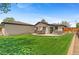 Expansive backyard with a well-manicured lawn, patio area, mature trees, and a detached garage at 9790 E 5Th Ave, Aurora, CO 80010