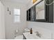 Modern bathroom with black vanity, ample storage, and a window for natural light at 9790 E 5Th Ave, Aurora, CO 80010