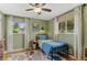 Charming bedroom with light green walls, hardwood floors, and a cozy single bed by two windows at 9790 E 5Th Ave, Aurora, CO 80010