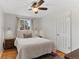 Comfortable bedroom with hardwood floors, neutral tones, and ample natural light from the window at 9790 E 5Th Ave, Aurora, CO 80010