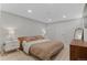 Neutral bedroom with hardwood furniture, a cozy bed, and recessed lighting at 9790 E 5Th Ave, Aurora, CO 80010