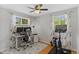 Bright office/bedroom space with two windows, desk, and a home exercise bike at 9790 E 5Th Ave, Aurora, CO 80010