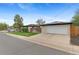 Exterior shot of a home with a spacious driveway leading to a two-car garage, complemented by a well-kept front lawn at 9790 E 5Th Ave, Aurora, CO 80010