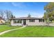Charming home featuring a manicured lawn, updated windows and a paved walkway leading to the front door at 9790 E 5Th Ave, Aurora, CO 80010