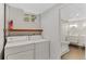 Bright laundry room with washer, dryer, shelving, and access to a renovated bathroom with a glass shower enclosure at 9790 E 5Th Ave, Aurora, CO 80010