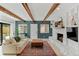Inviting living room featuring vaulted ceilings with beams, a fireplace, and access to the backyard at 9790 E 5Th Ave, Aurora, CO 80010
