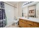 Functional bathroom featuring a shower-tub combo, a vanity, and a large mirror at 14221 E 1St Dr # 303, Aurora, CO 80011