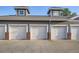 A row of garages with white doors and brick pillars, providing convenient parking at 14221 E 1St Dr # 303, Aurora, CO 80011