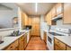 Efficient kitchen featuring oak cabinets, white appliances, and hardwood floors at 14221 E 1St Dr # 303, Aurora, CO 80011