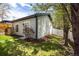 A lush backyard features a garden shed, manicured lawn, and a white fence for privacy at 3504 Newton St, Denver, CO 80211