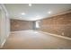 Basement with carpet and an exposed brick wall at 3504 Newton St, Denver, CO 80211