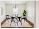 Modern dining room featuring a glass table, six chairs, contemporary lighting, and hardwood floors at 3504 Newton St, Denver, CO 80211