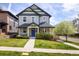 A charming two-story home with a welcoming blue front door and a beautifully landscaped front yard at 3504 Newton St, Denver, CO 80211