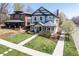 Charming two-story home with inviting front porch, manicured lawn, and beautiful landscaping at 3504 Newton St, Denver, CO 80211