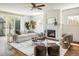 Bright living room features hardwood floors, fireplace, large windows, and stylish decor at 3504 Newton St, Denver, CO 80211