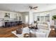 Bright living room seamlessly connects to the kitchen, offering an open and airy living space at 3504 Newton St, Denver, CO 80211
