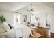 Spacious main bedroom with hardwood floors, vaulted ceiling, bright windows, and modern decor at 3504 Newton St, Denver, CO 80211