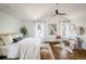 Spacious main bedroom with hardwood floors, vaulted ceiling, bright windows, and modern decor at 3504 Newton St, Denver, CO 80211