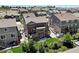 Aerial view of a backyard with a patio, lush lawn, mature trees, and privacy fence at 20855 Park Hollow Dr, Parker, CO 80138