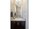 Half-bathroom featuring vanity with dark wood cabinets, gray countertop, silver hardware and faucet, and decor accents at 20855 Park Hollow Dr, Parker, CO 80138