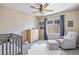 Charming Bedroom with a crib, comfortable chair, and a large window allowing for plenty of natural light at 20855 Park Hollow Dr, Parker, CO 80138