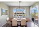 Inviting dining room featuring a wood table, modern light fixture, and sliding glass doors to the deck at 20855 Park Hollow Dr, Parker, CO 80138