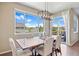 Bright dining room with a large window, wood table, chandelier, and seating for six at 20855 Park Hollow Dr, Parker, CO 80138