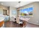 Bright dining area with hardwood floors, a large window, and a stylish light fixture above a wooden table at 20855 Park Hollow Dr, Parker, CO 80138