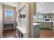 Functional mudroom area with built-in storage, desk, and bench seating, leading to the kitchen at 20855 Park Hollow Dr, Parker, CO 80138