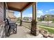 Charming front porch with stone accents, seating, and a view of the neighborhood at 20855 Park Hollow Dr, Parker, CO 80138