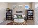 Cozy home office featuring a comfortable couch, bookshelves, and a decorative rug at 20855 Park Hollow Dr, Parker, CO 80138