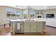 Open-concept kitchen with stainless appliances, a center island, and hardwood floors flows into the living room at 20855 Park Hollow Dr, Parker, CO 80138