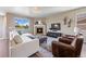 Comfortable living room with a fireplace, large sectional sofa, and views of the surrounding landscape at 20855 Park Hollow Dr, Parker, CO 80138