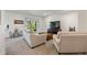 Bright living room with neutral-toned furnishings, a TV, and a sliding glass door to the outside at 20855 Park Hollow Dr, Parker, CO 80138