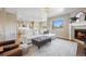 Open-concept living area with fireplace, comfortable seating, and seamless transition to the kitchen at 20855 Park Hollow Dr, Parker, CO 80138